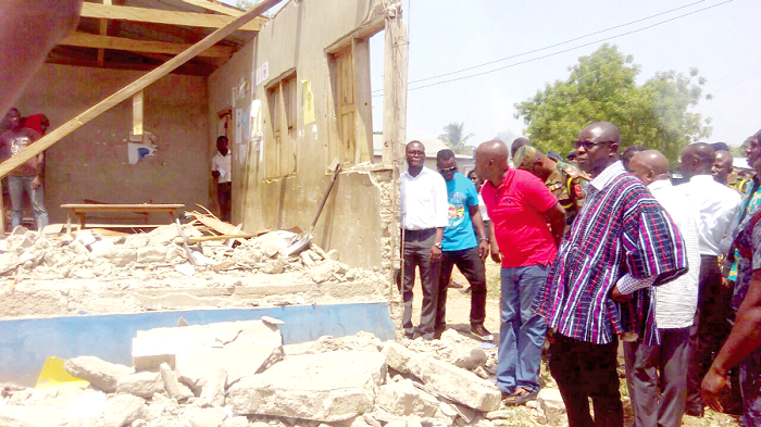 Mr Kwaku Asoma-Cheremeh (in smock) and other officials inspecting the extent of damage